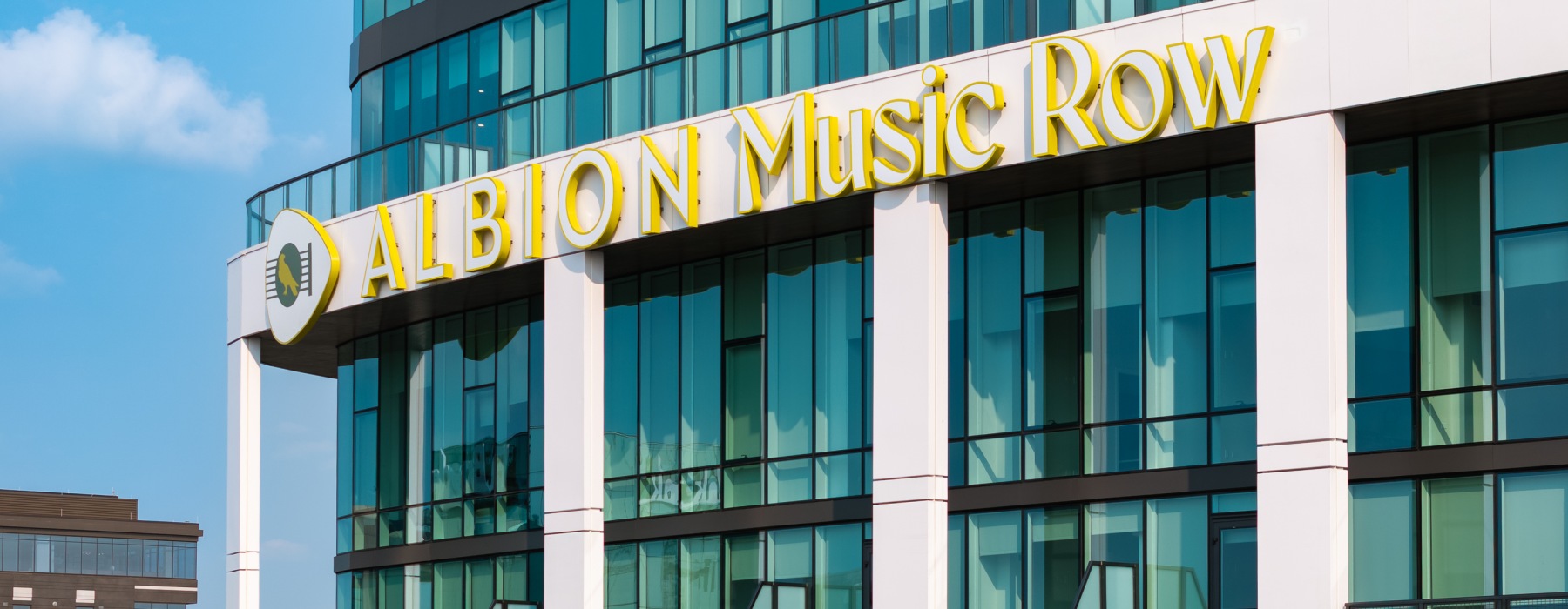 Monument sign on Albion Music Row high rise apartment living building in Nashville, TN
