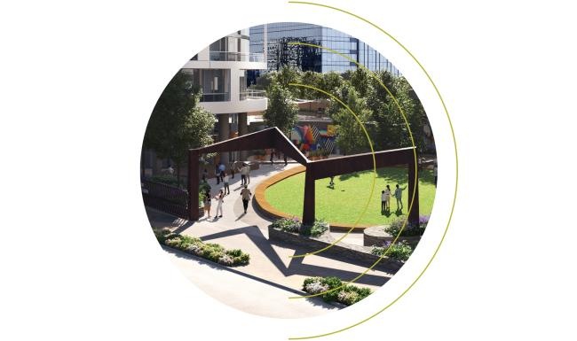 a circular reflective object with people walking around it